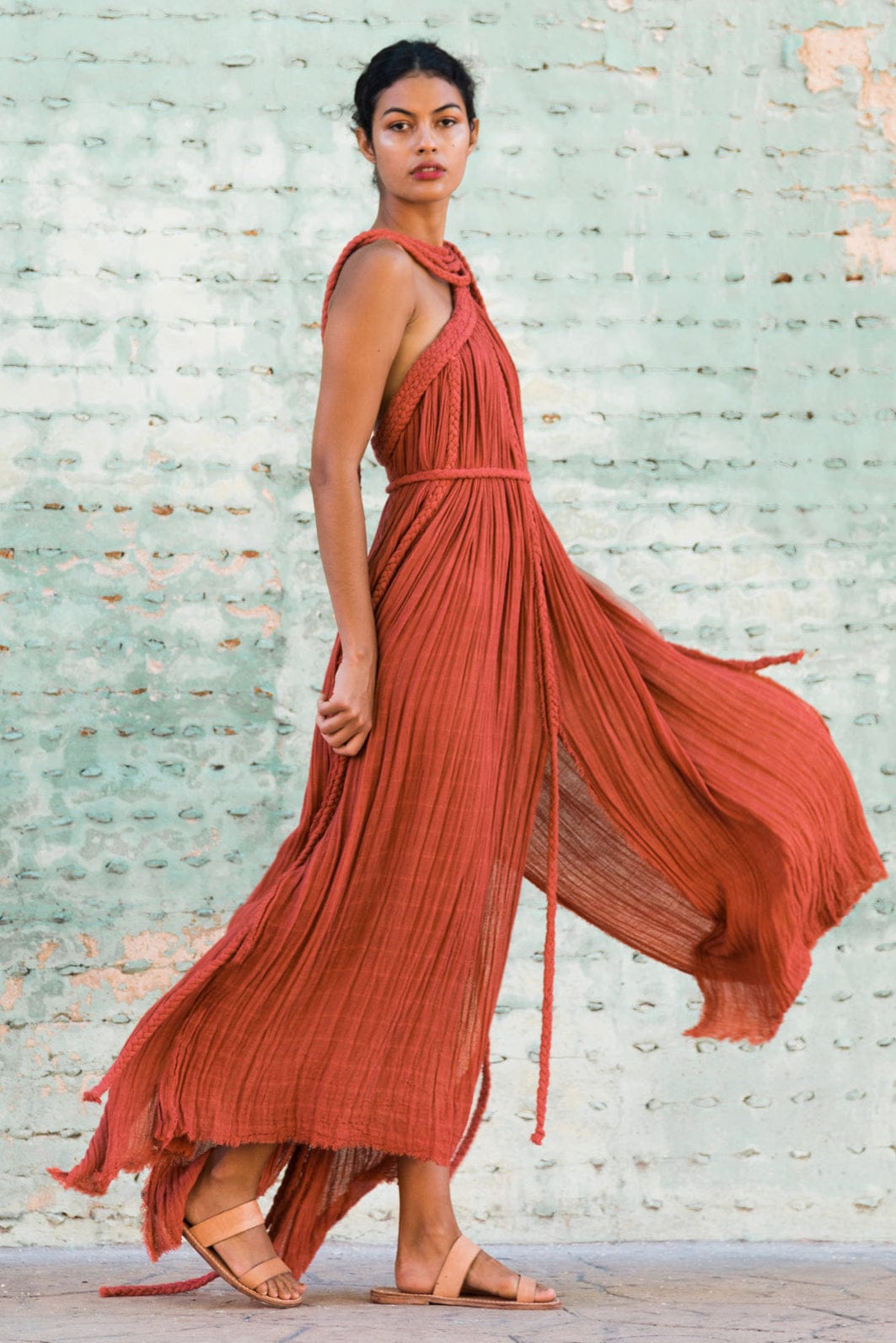 rust-orange bohemian maxi dress with a flowy, textured silhouette and unique rope detailing. It’s both effortless and artistic, perfect for someone who wants to make a natural yet bold statement.