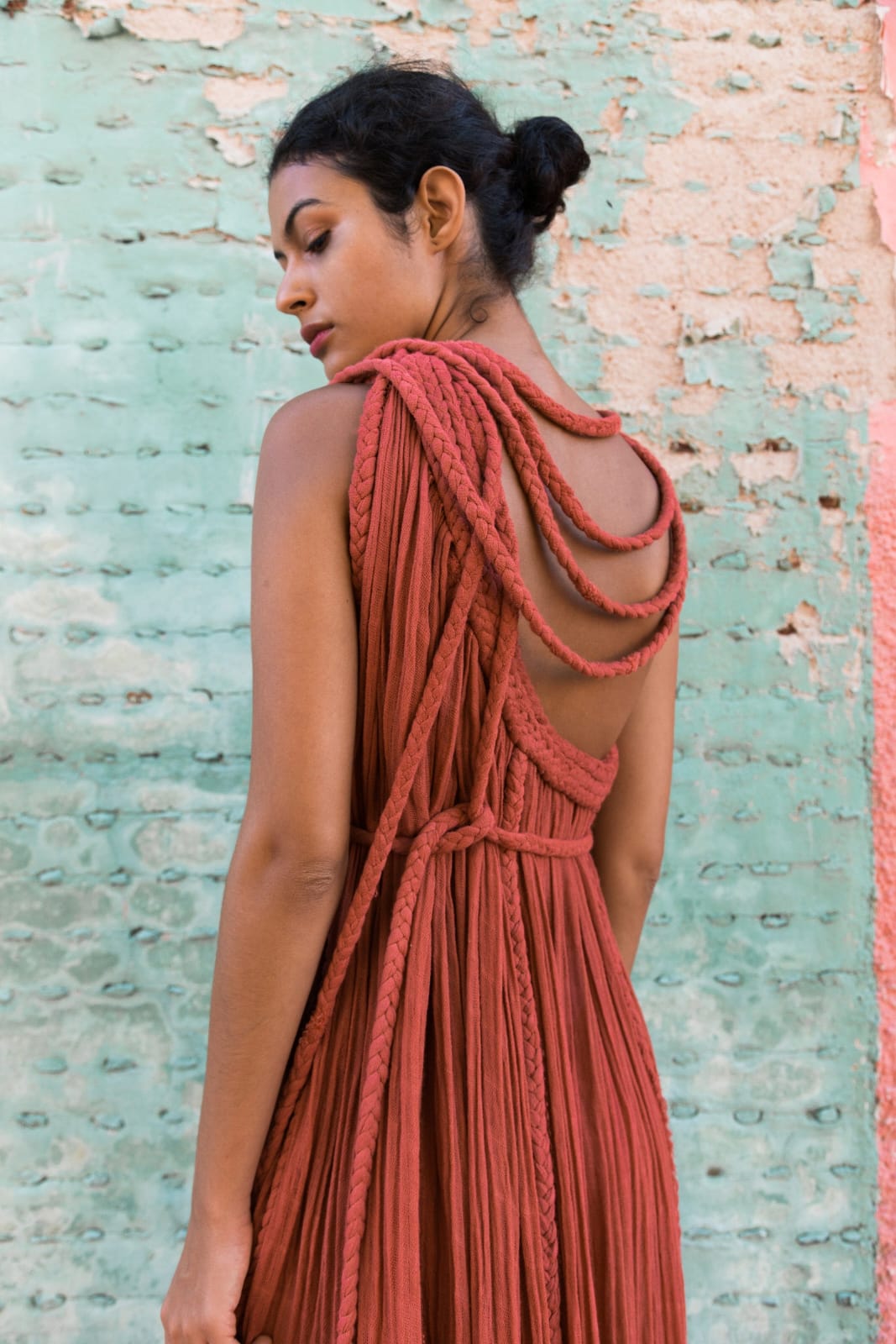 rust-orange bohemian maxi dress with a flowy, textured silhouette and unique rope detailing. It’s both effortless and artistic, perfect for someone who wants to make a natural yet bold statement.