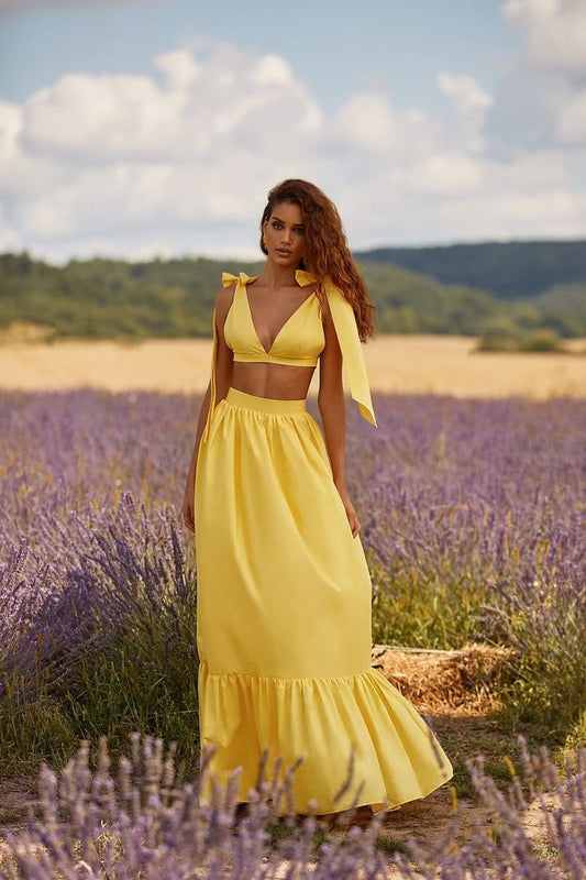 vibrant yellow two-piece resortwear set designed for sun-drenched escapes, garden parties, and chic summer getaways. Radiating joy and elegance, the ensemble combines vintage charm with contemporary flair.