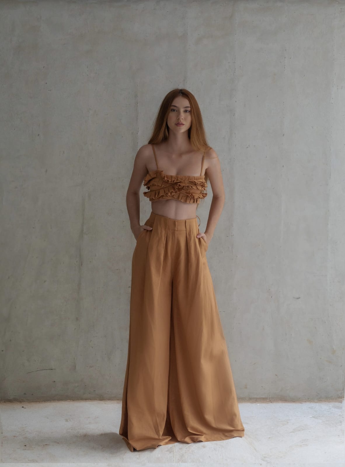 chic two-piece co-ord set in a warm caramel or camel brown shade, blending softness with subtle drama for a relaxed yet fashion-forward aesthetic.