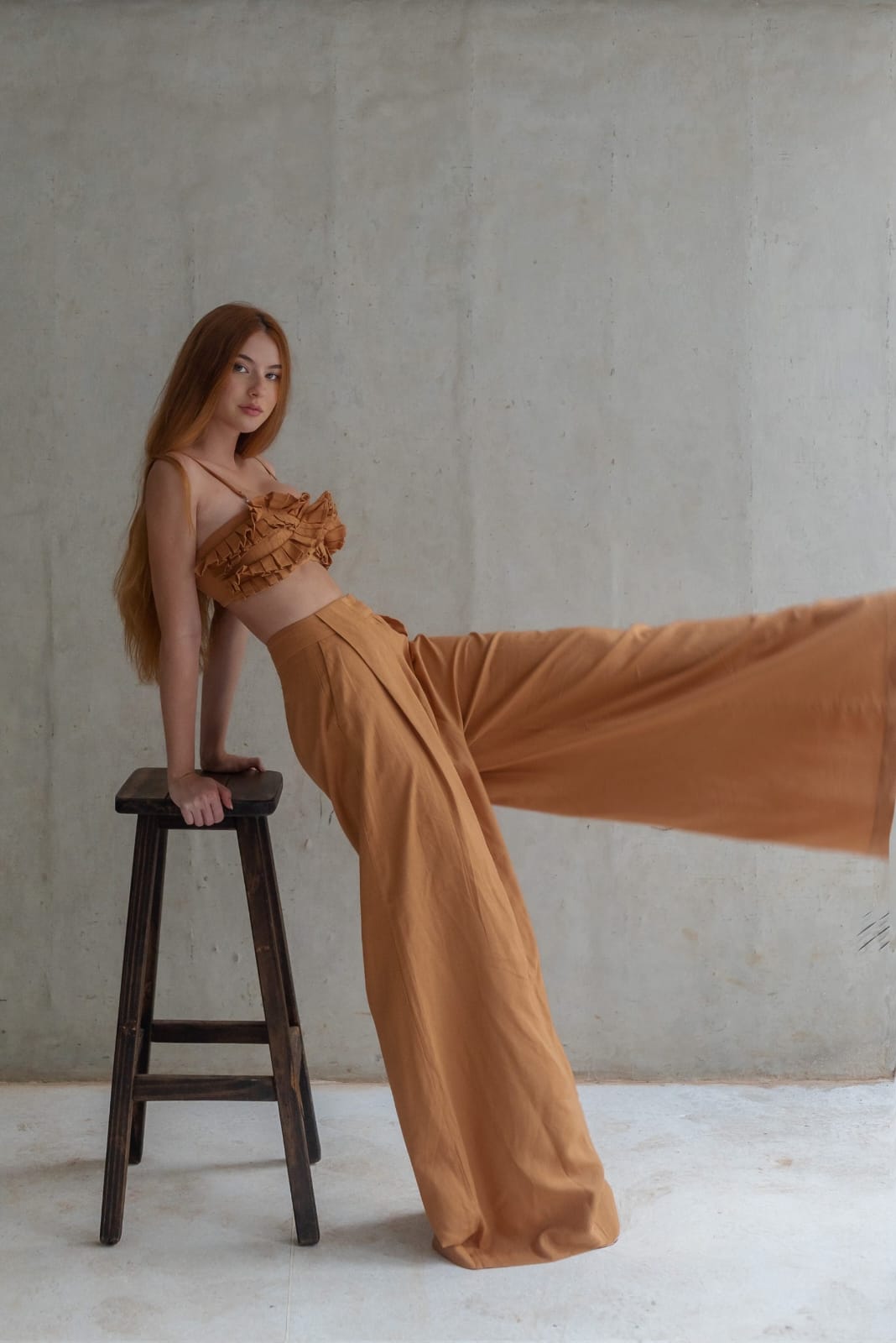 chic two-piece co-ord set in a warm caramel or camel brown shade, blending softness with subtle drama for a relaxed yet fashion-forward aesthetic.