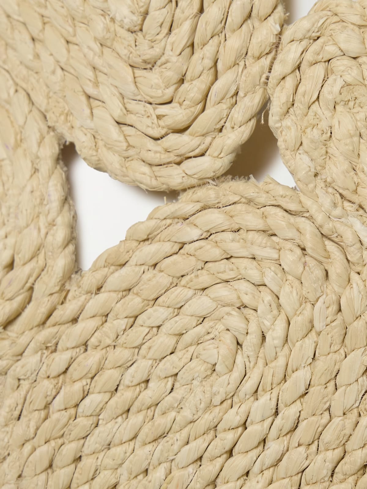 woven bandeau-style crop top. It is crafted from a natural, straw-like rope material, giving it a rustic, handcrafted, and beachy aesthetic