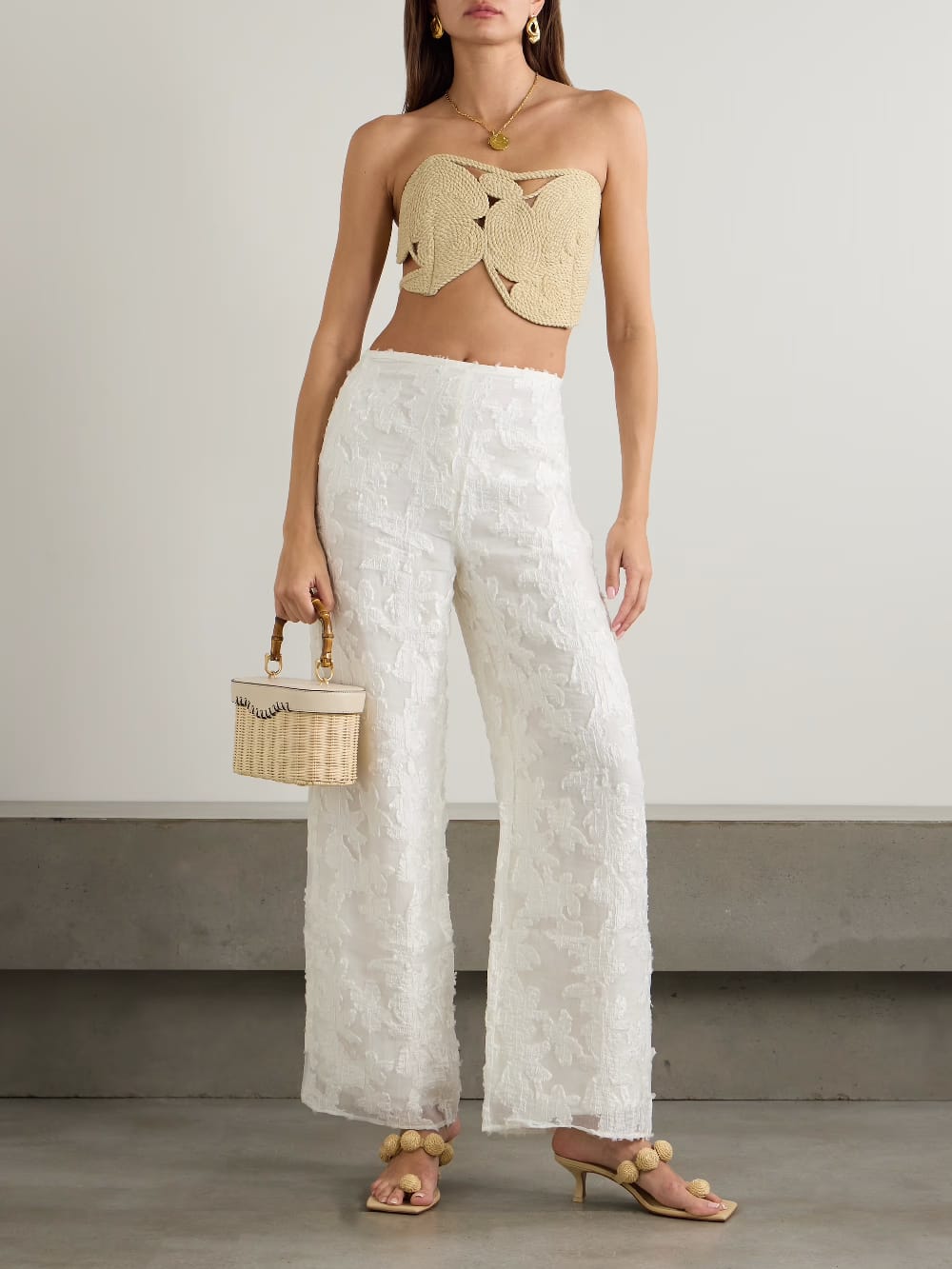 woven bandeau-style crop top. It is crafted from a natural, straw-like rope material, giving it a rustic, handcrafted, and beachy aesthetic