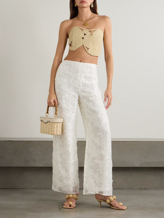 woven bandeau-style crop top. It is crafted from a natural, straw-like rope material, giving it a rustic, handcrafted, and beachy aesthetic